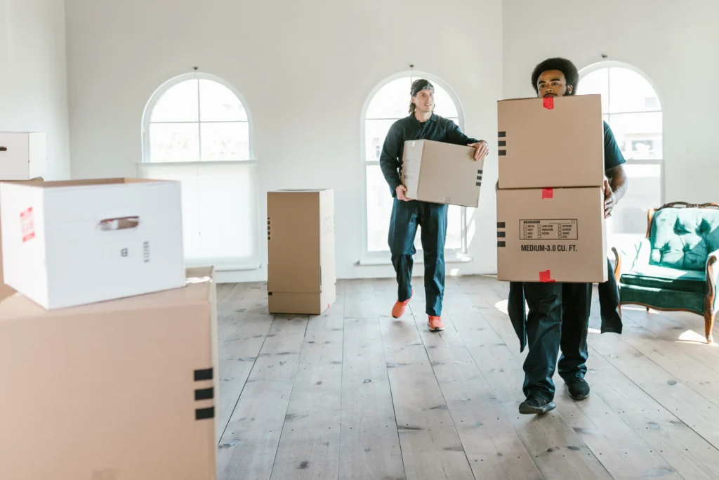 Professional movers carrying a sofa during a furniture move in Palm Jumeirah, Dubai