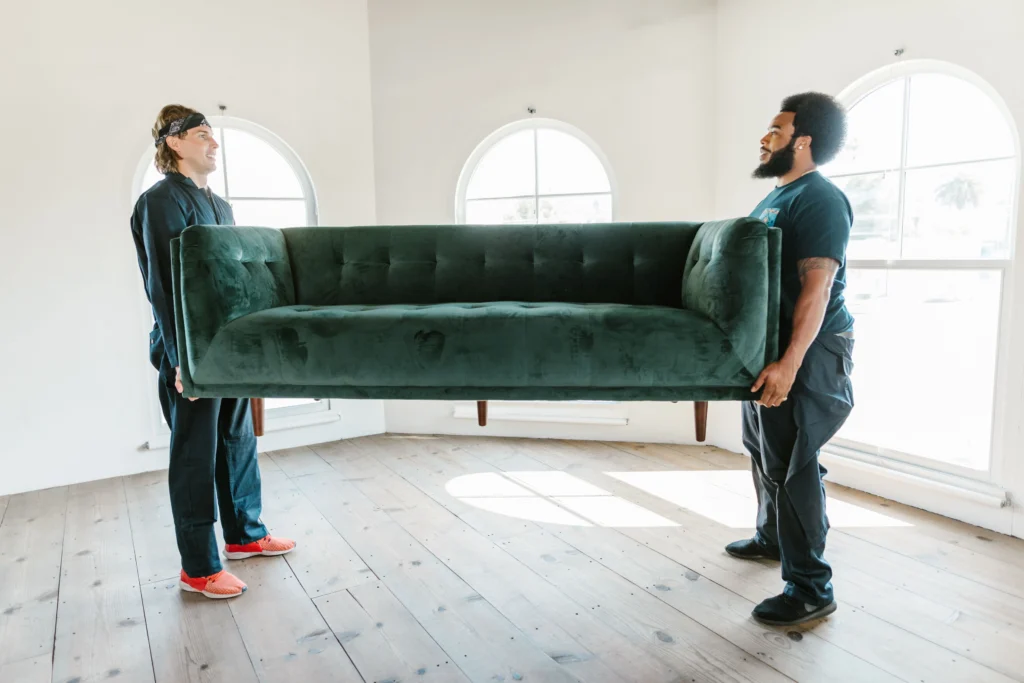 Team working in a home, moving furniture in Business Bay