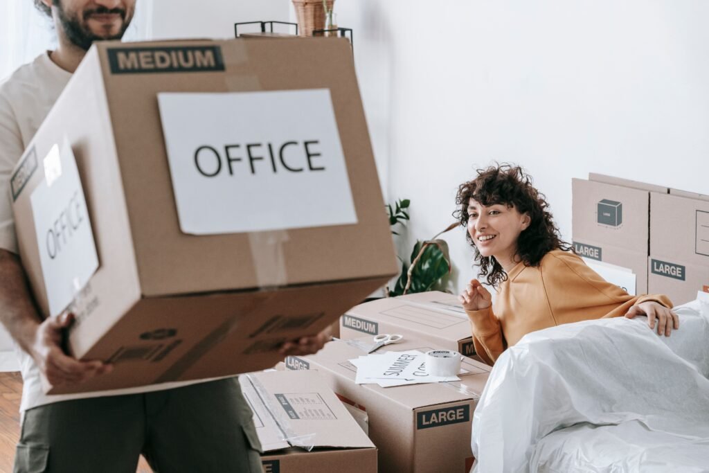 Employee carrying a packed box during an office move in Dubai